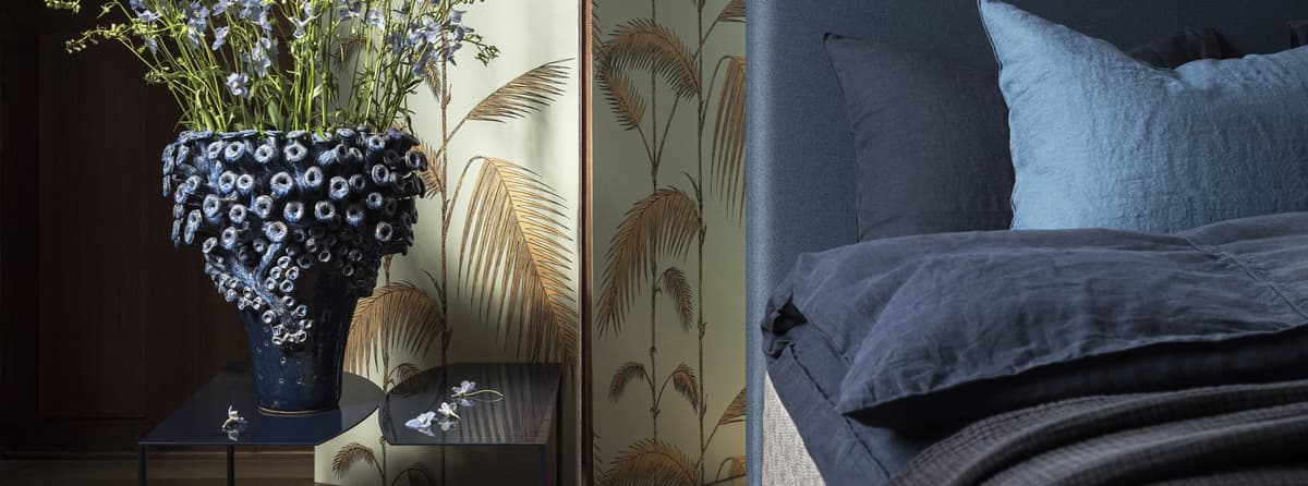 Close-up of the DUX bed model 1001 with blue Astoria headboard.